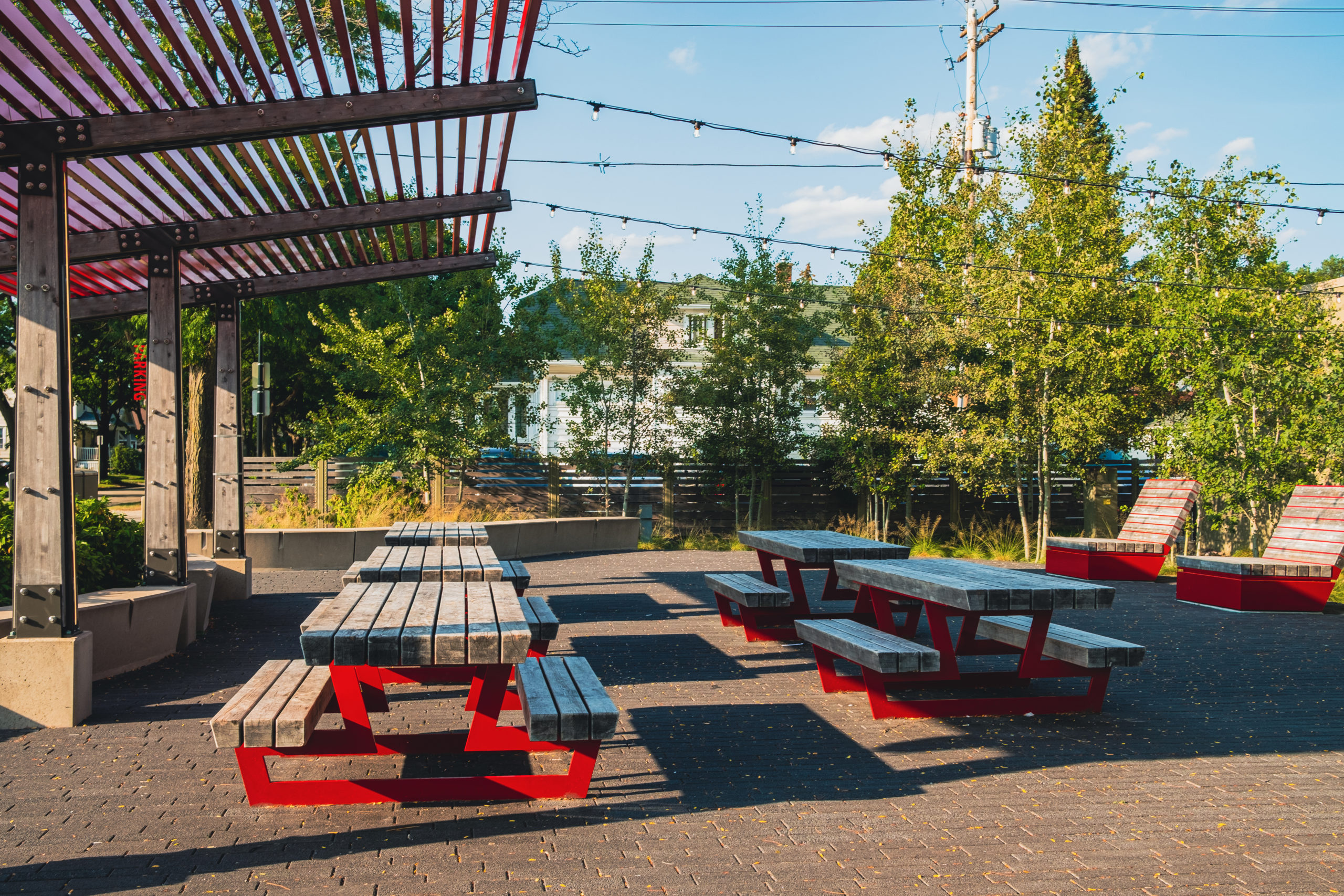 69th St. Plaza in East Tosa with picnic benches and trees in the background