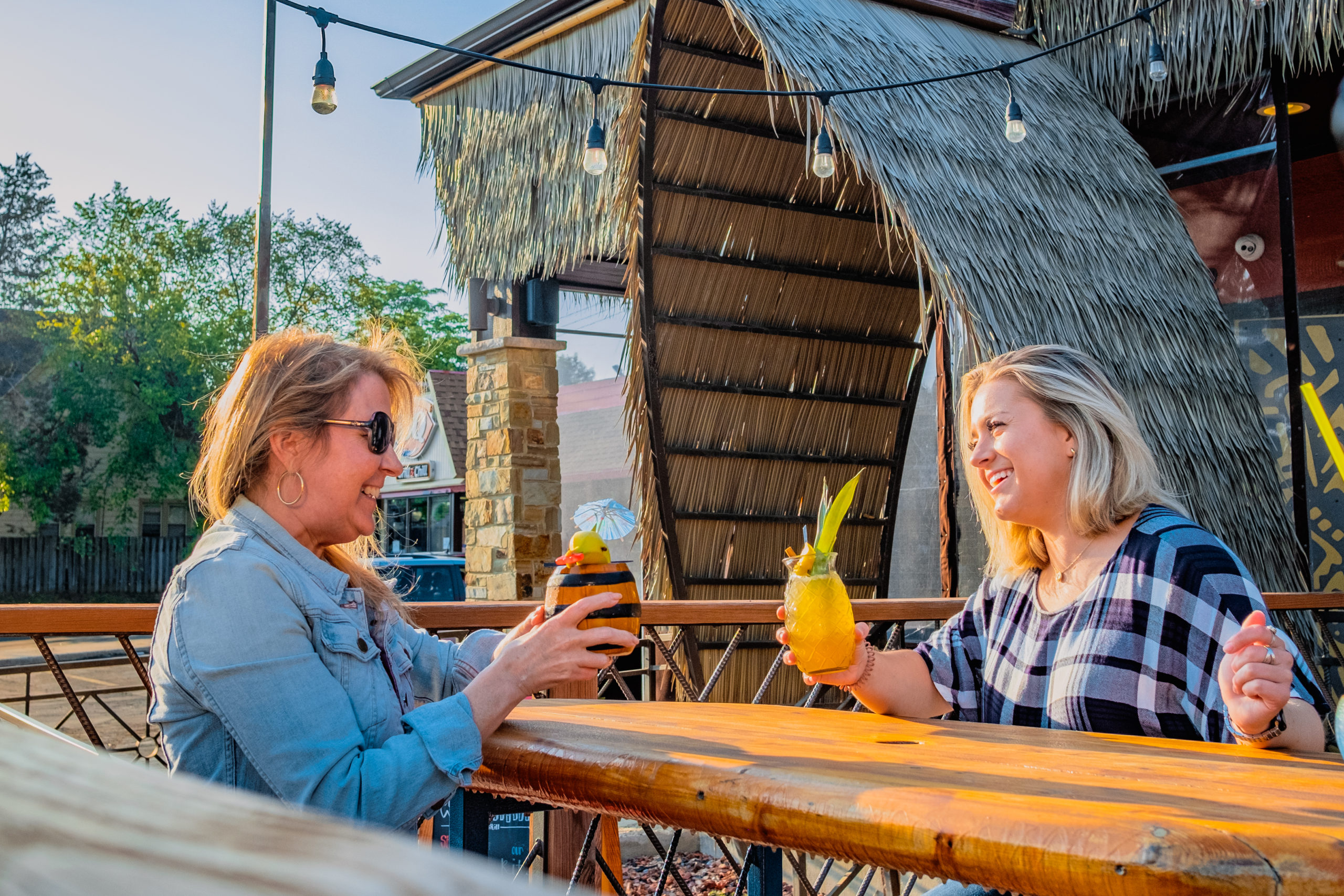 Two people getting drinks outdoors at Wauwaiki